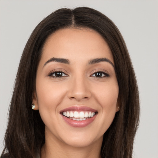 Joyful white young-adult female with long  brown hair and brown eyes