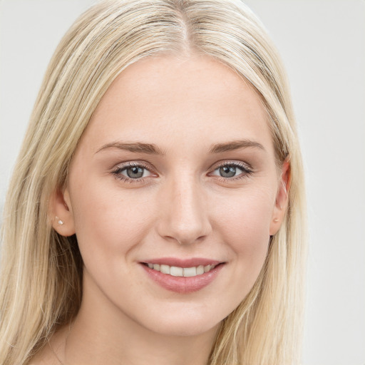 Joyful white young-adult female with long  brown hair and blue eyes