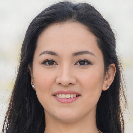 Joyful asian young-adult female with long  brown hair and brown eyes