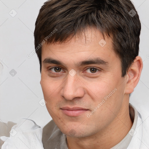 Joyful white young-adult male with short  brown hair and brown eyes