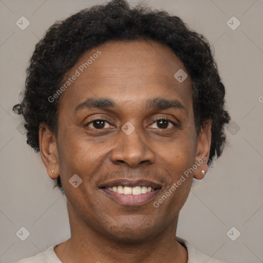 Joyful black adult male with short  brown hair and brown eyes