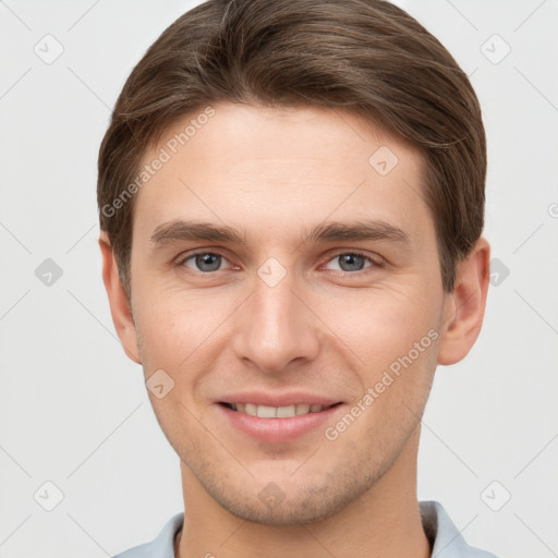 Joyful white young-adult male with short  brown hair and grey eyes