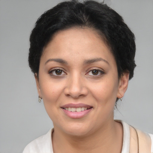 Joyful latino young-adult female with short  brown hair and brown eyes