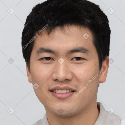 Joyful asian young-adult male with short  black hair and brown eyes