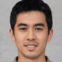 Joyful asian young-adult male with short  black hair and brown eyes