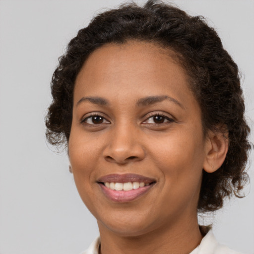Joyful latino adult female with medium  brown hair and brown eyes