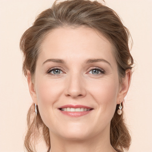 Joyful white young-adult female with long  brown hair and grey eyes