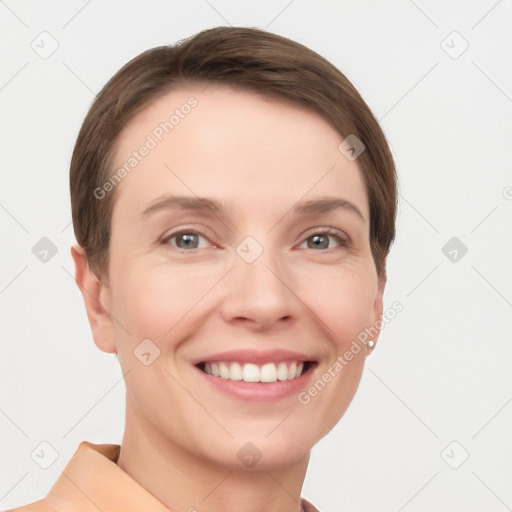 Joyful white young-adult female with short  brown hair and grey eyes