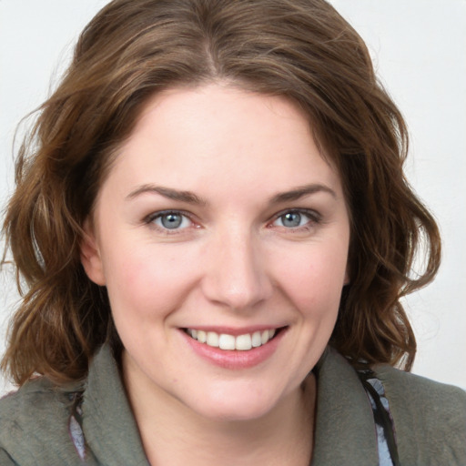 Joyful white young-adult female with medium  brown hair and grey eyes