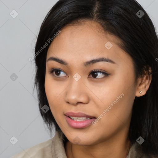 Joyful asian young-adult female with long  brown hair and brown eyes