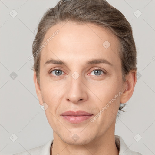 Joyful white adult male with short  brown hair and grey eyes