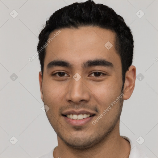 Joyful white young-adult male with short  black hair and brown eyes