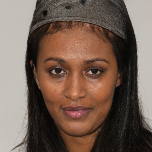 Joyful black adult female with long  brown hair and brown eyes