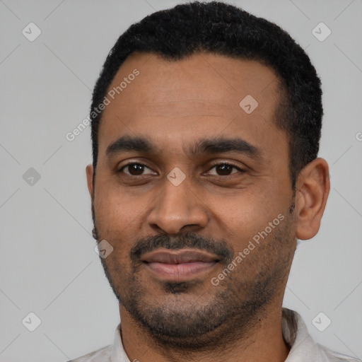 Joyful latino young-adult male with short  black hair and brown eyes