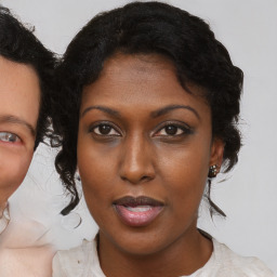 Joyful black young-adult female with medium  brown hair and brown eyes