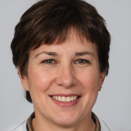 Joyful white adult female with short  brown hair and brown eyes