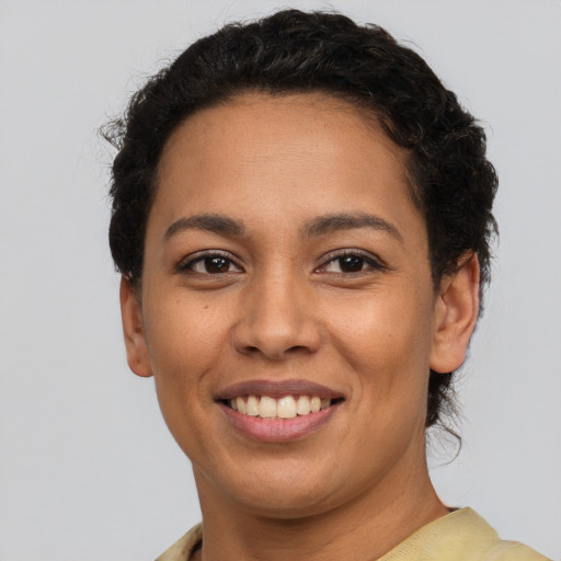 Joyful latino young-adult female with short  brown hair and brown eyes