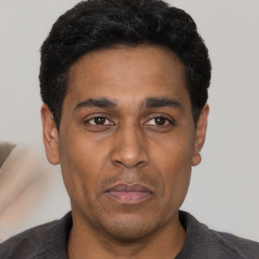 Neutral latino adult male with short  black hair and brown eyes