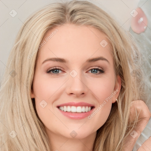 Joyful white young-adult female with long  brown hair and blue eyes