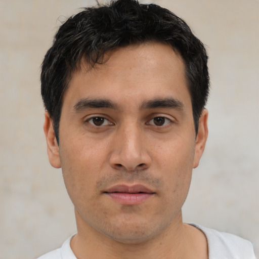 Joyful asian young-adult male with short  black hair and brown eyes