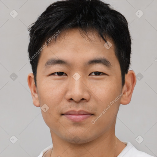 Joyful asian young-adult male with short  black hair and brown eyes