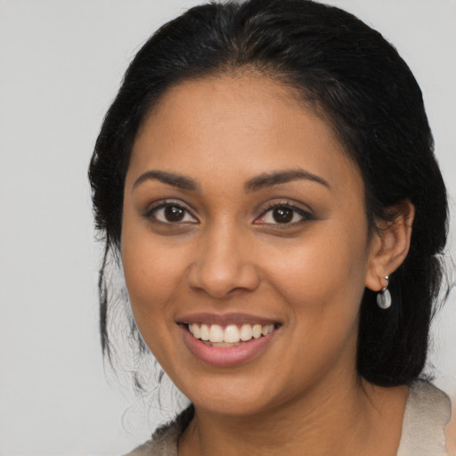 Joyful latino young-adult female with medium  black hair and brown eyes