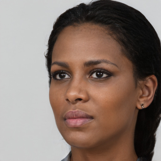 Neutral black young-adult female with medium  black hair and brown eyes