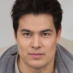 Joyful asian young-adult male with short  brown hair and brown eyes