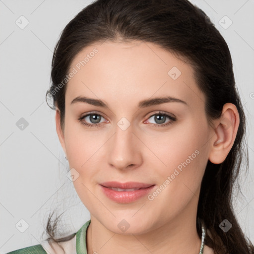 Joyful white young-adult female with medium  brown hair and grey eyes