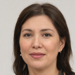 Joyful white adult female with medium  brown hair and brown eyes