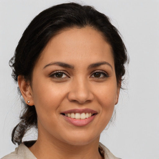 Joyful latino young-adult female with medium  brown hair and brown eyes