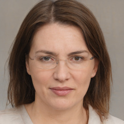 Joyful white adult female with medium  brown hair and grey eyes