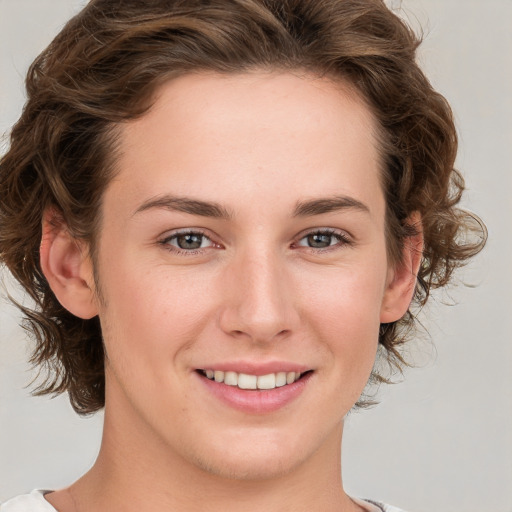 Joyful white young-adult female with medium  brown hair and blue eyes