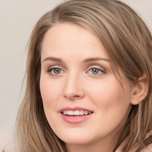 Joyful white young-adult female with long  brown hair and grey eyes