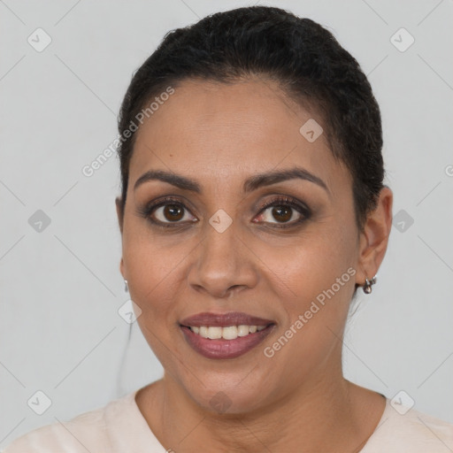 Joyful latino young-adult female with short  brown hair and brown eyes