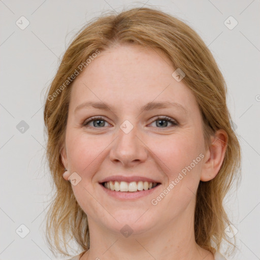 Joyful white young-adult female with medium  brown hair and blue eyes