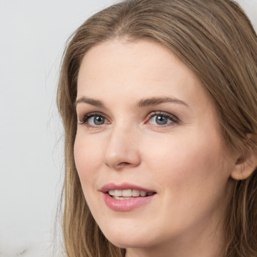 Joyful white young-adult female with long  brown hair and grey eyes