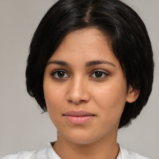 Joyful latino young-adult female with medium  black hair and brown eyes