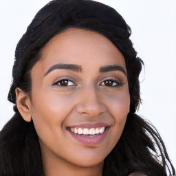 Joyful latino young-adult female with long  black hair and brown eyes