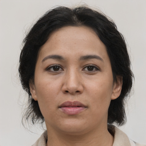 Joyful asian adult female with medium  brown hair and brown eyes