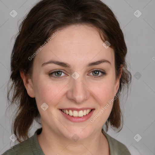 Joyful white young-adult female with medium  brown hair and green eyes