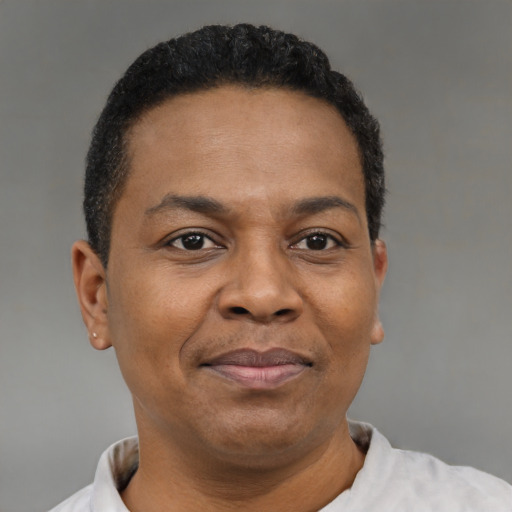 Joyful black adult male with short  brown hair and brown eyes