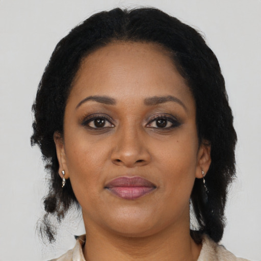 Joyful black adult female with medium  black hair and brown eyes