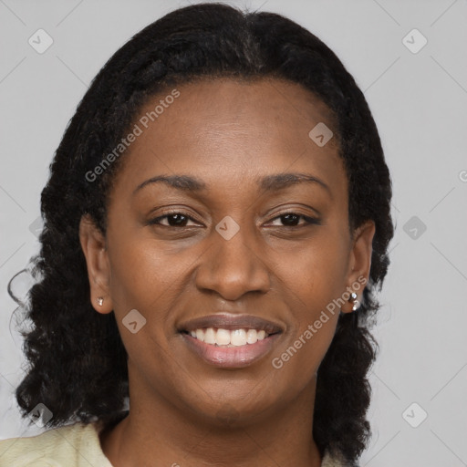 Joyful black young-adult female with long  brown hair and brown eyes