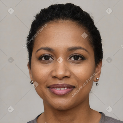 Joyful black young-adult female with short  black hair and brown eyes