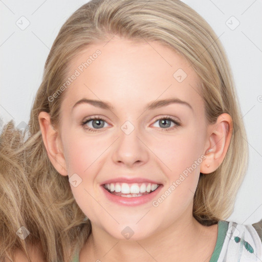 Joyful white young-adult female with long  brown hair and blue eyes