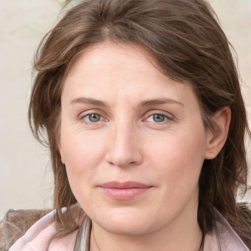 Joyful white young-adult female with medium  brown hair and blue eyes