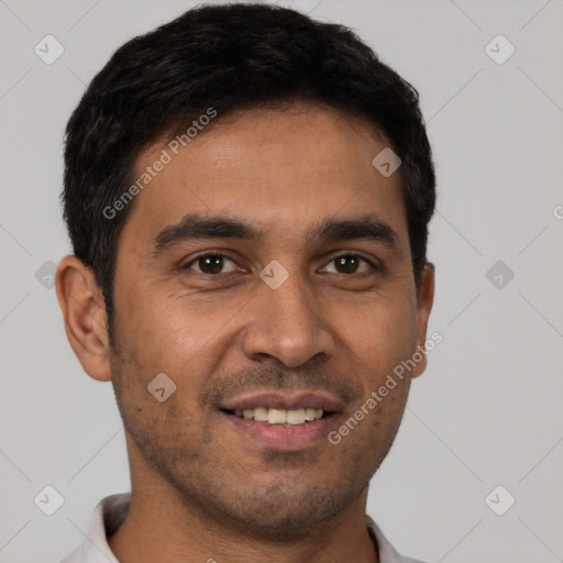 Joyful white young-adult male with short  black hair and brown eyes