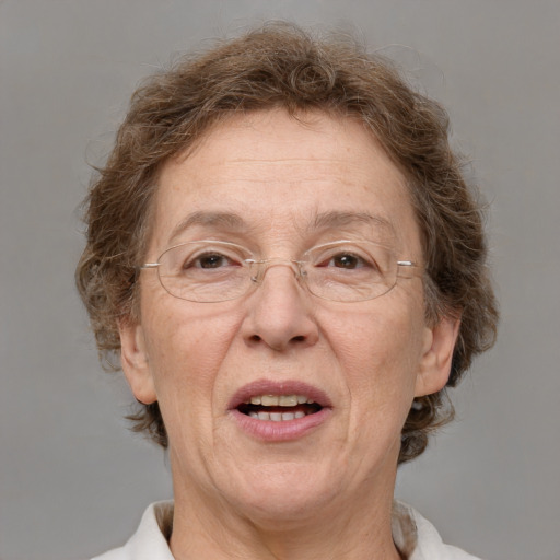 Joyful white middle-aged female with medium  brown hair and blue eyes