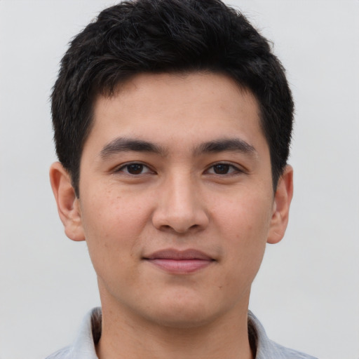 Joyful latino young-adult male with short  brown hair and brown eyes